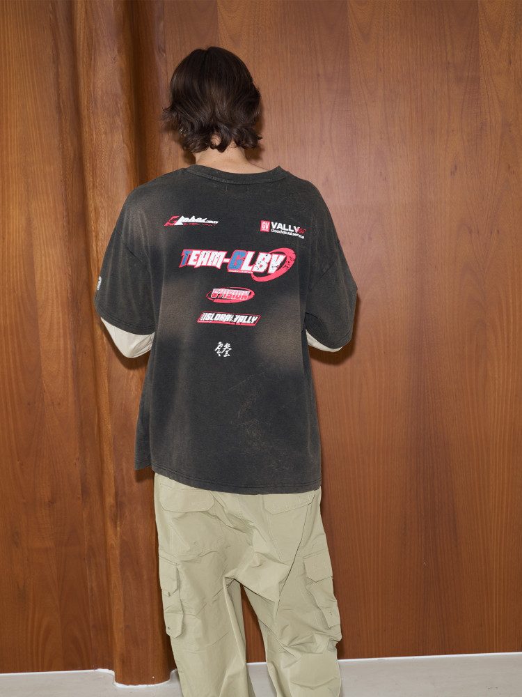 Back view of the layered-sleeve tee showing the back print in wear