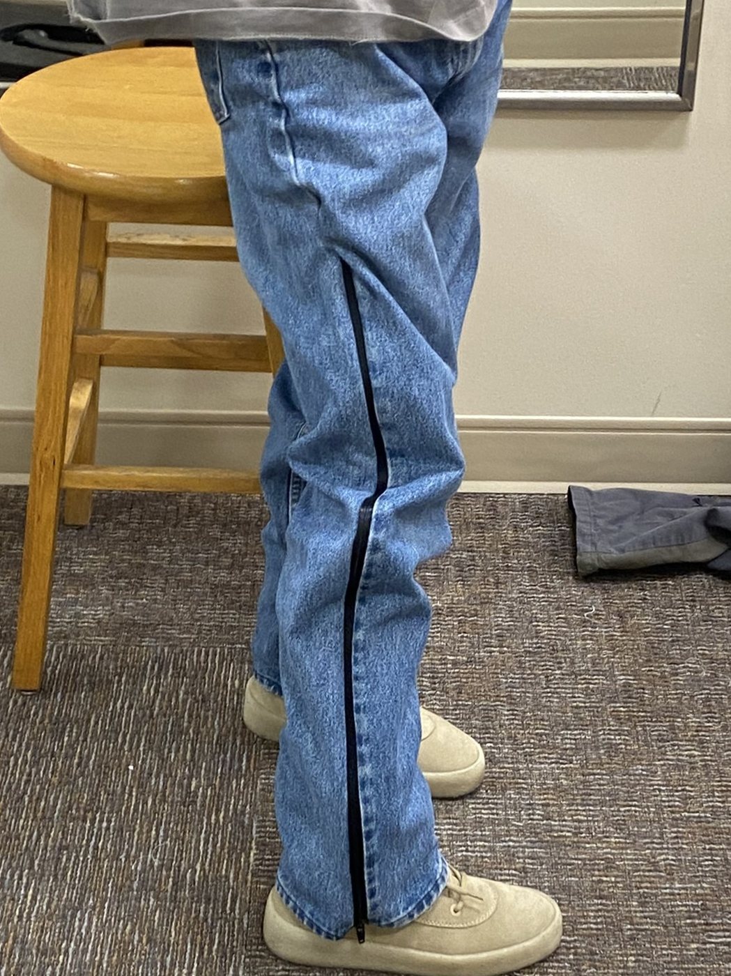 Trouser with the side zip closed, reading as plain denim