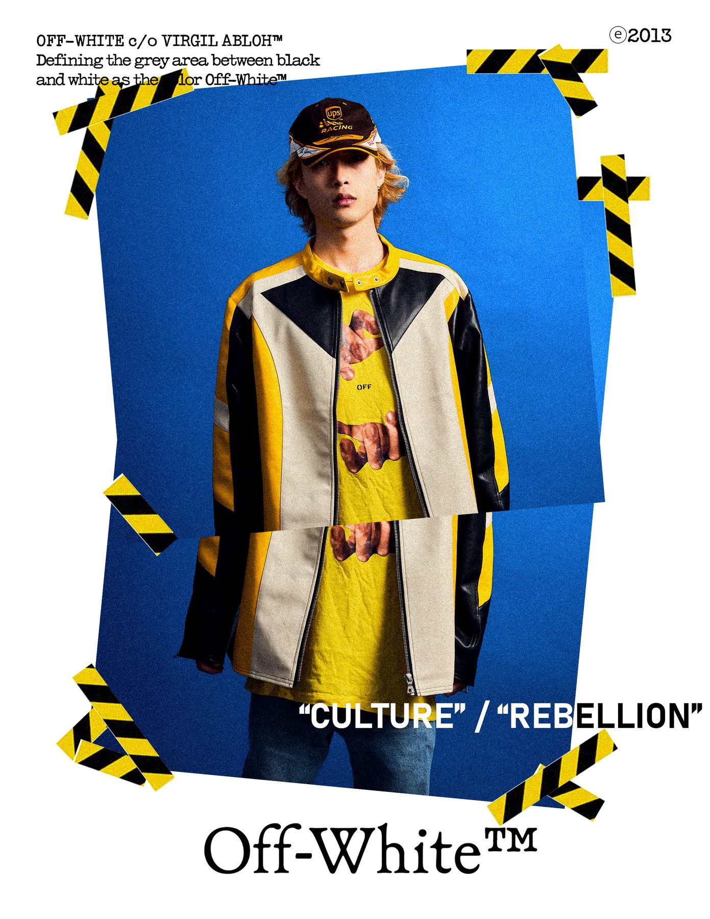 Model in a yellow and cream moto jacket and racing cap on a blue ground, hazard tape framing