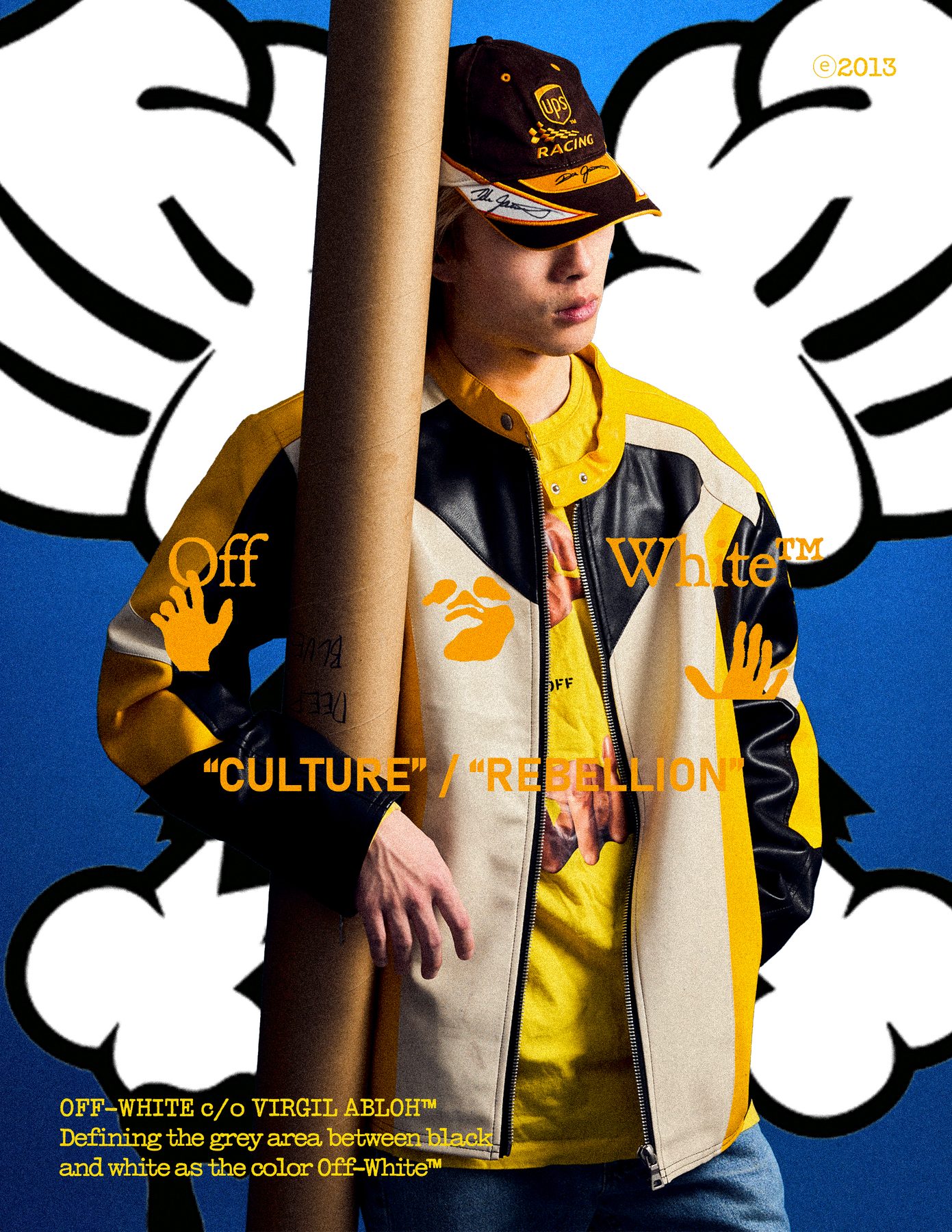 Model leaning on a mailing tube, graphic hands enlarged behind