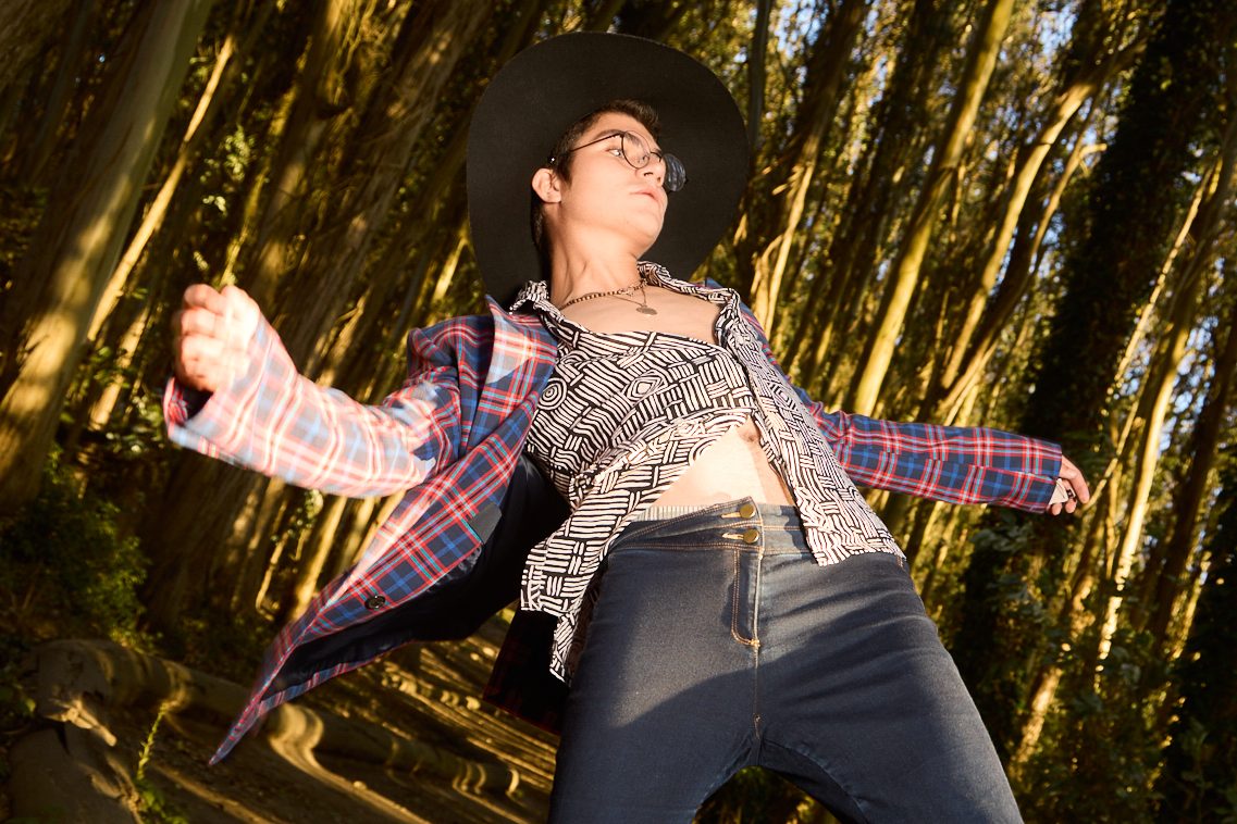 Low angle, arms thrown out, shot from below on the log