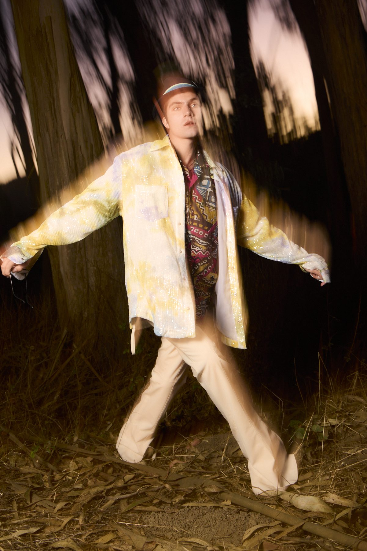 Model mid-stride with arms out, background streaked by motion